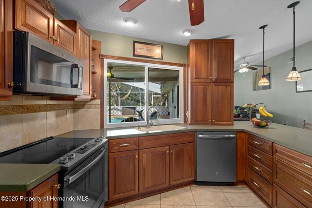 204 Oak Lake Dr, Spring Hill, FL 34608 - kitchen featuring a ceiling fan, appliances with stainless steel finishes, brown cabinets, and backsplash