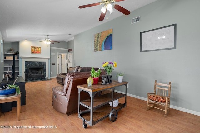 204 Oak Lake Dr, Spring Hill, FL 34608 - living area featuring a ceiling fan, light wood-style floors, and a high end fireplace