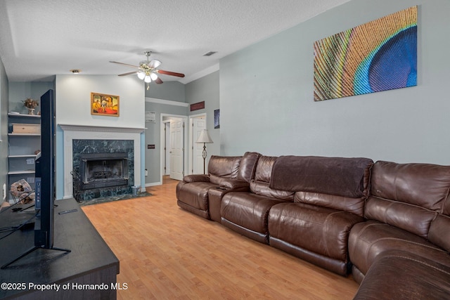 204 Oak Lake Dr, Spring Hill, FL 34608 - living area with ceiling fan, wood finished floors, a premium fireplace, and a textured ceiling