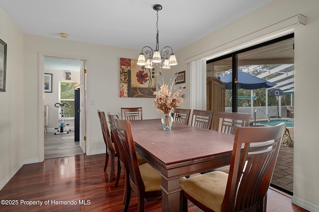 204 Oak Lake Dr, Spring Hill, FL 34608 - dining area featuring a chandelier, plenty of natural light, and wood finished floors