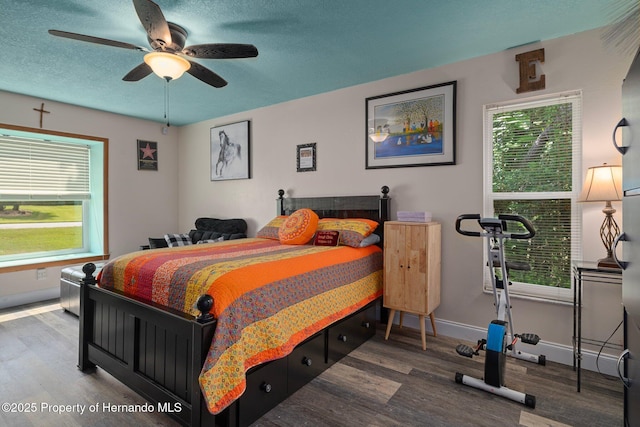 204 Oak Lake Dr, Spring Hill, FL 34608 - bedroom with wood finished floors, multiple windows, and a ceiling fan
