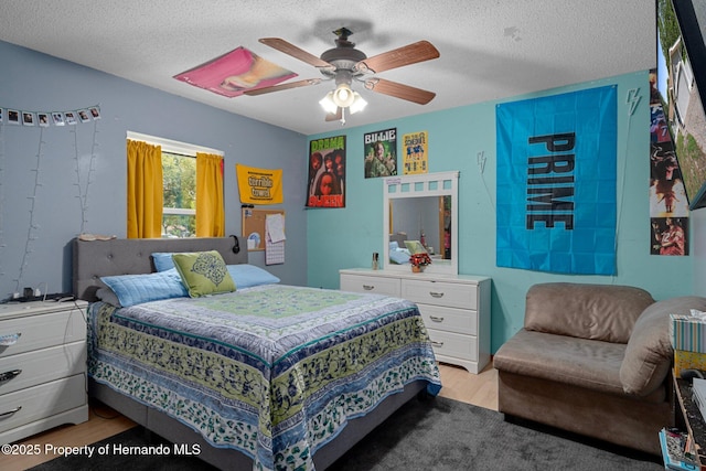 204 Oak Lake Dr, Spring Hill, FL 34608 - bedroom with light wood finished floors, a textured ceiling, and ceiling fan