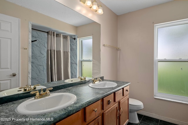 204 Oak Lake Dr, Spring Hill, FL 34608 - bathroom with double vanity, curtained shower, and tile patterned floors