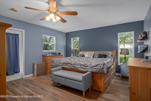204 Oak Lake Dr, Spring Hill, FL 34608 - bedroom featuring wood finished floors, multiple windows, and a ceiling fan