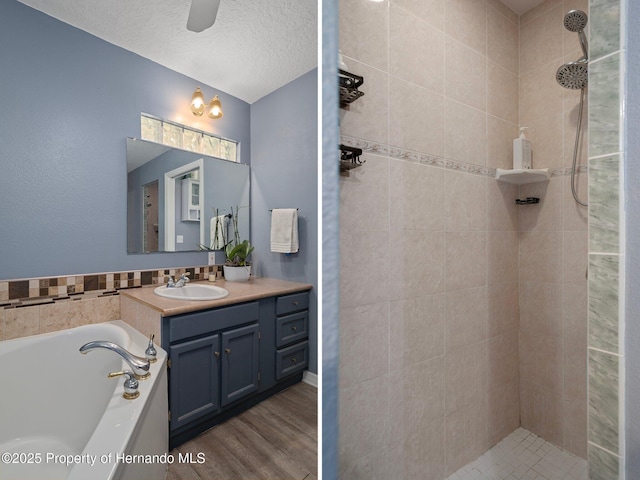 204 Oak Lake Dr, Spring Hill, FL 34608 - full bathroom with vanity, a tile shower, a bath, wood finished floors, and a textured ceiling