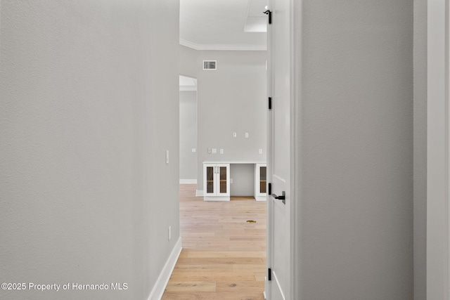 5018 Elm Leaf Dr, Brooksville, FL 34601 - corridor with crown molding and light wood-style floors