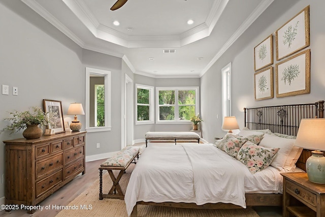 5018 Elm Leaf Dr, Brooksville, FL 34601 - bedroom with a raised ceiling, crown molding, light wood-style floors, recessed lighting, and ceiling fan
