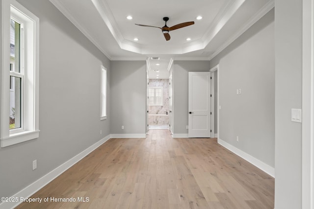 5018 Elm Leaf Dr, Brooksville, FL 34601 - empty room featuring a tray ceiling, light wood-style floors, ceiling fan, recessed lighting, and crown molding