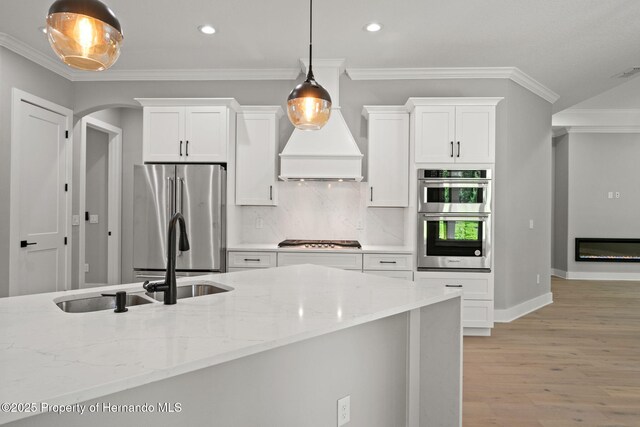 5018 Elm Leaf Dr, Brooksville, FL 34601 - kitchen featuring appliances with stainless steel finishes, white cabinetry, recessed lighting, light wood-style floors, and light stone counters
