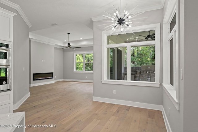 5018 Elm Leaf Dr, Brooksville, FL 34601 - unfurnished living room featuring crown molding, a ceiling fan, light wood-type flooring, a glass covered fireplace, and a chandelier