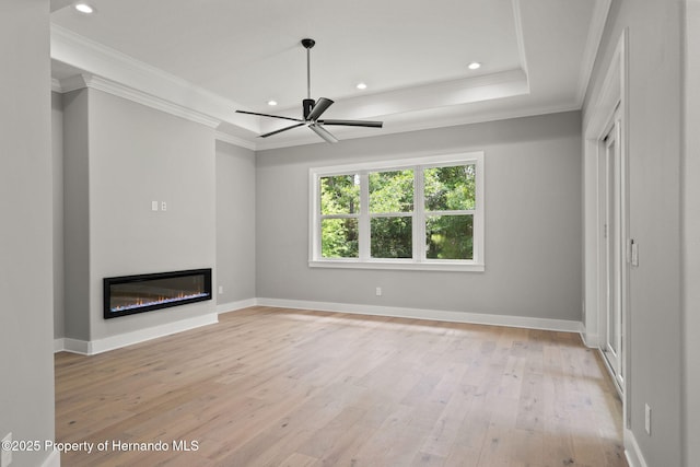 5018 Elm Leaf Dr, Brooksville, FL 34601 - unfurnished living room with a glass covered fireplace, ornamental molding, light wood-style flooring, recessed lighting, and a ceiling fan