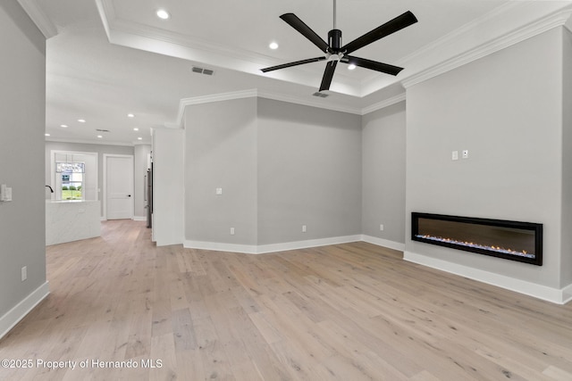5018 Elm Leaf Dr, Brooksville, FL 34601 - unfurnished living room featuring crown molding, light wood finished floors, a glass covered fireplace, a ceiling fan, and recessed lighting