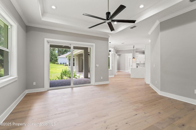 5018 Elm Leaf Dr, Brooksville, FL 34601 - empty room with crown molding, ceiling fan, a tray ceiling, light wood-type flooring, and recessed lighting