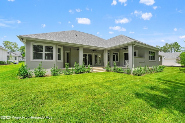 5018 Elm Leaf Dr, Brooksville, FL 34601 - back of house with ceiling fan, a yard, and stucco siding