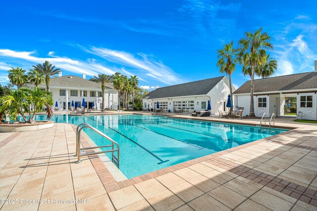 5018 Elm Leaf Dr, Brooksville, FL 34601 - community pool with a patio