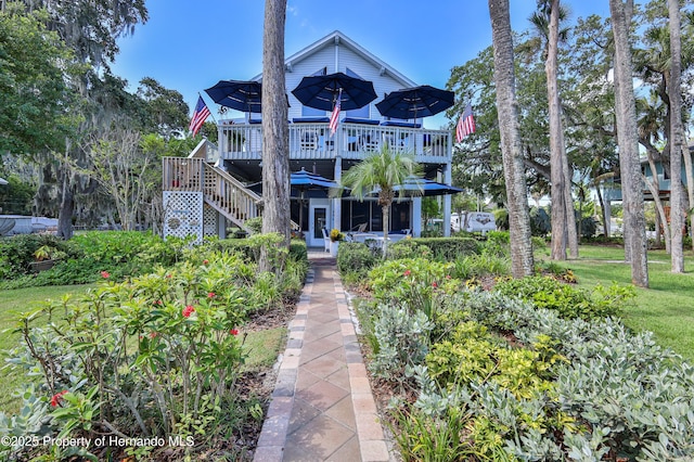 5233 Tuscawilla Dr, Weeki Wachee, FL 34607 - back of property with a deck and stairs