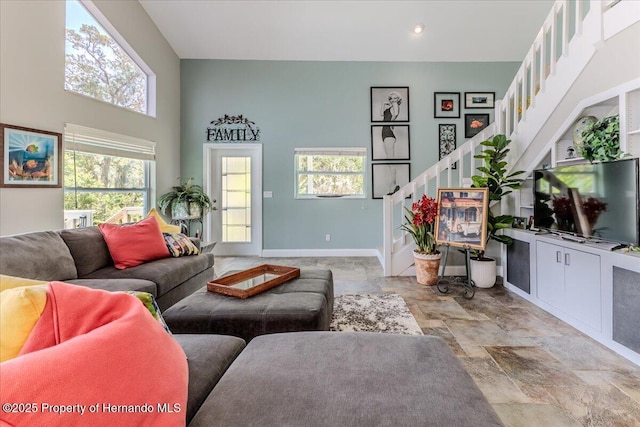 5233 Tuscawilla Dr, Weeki Wachee, FL 34607 - living area featuring stairway, plenty of natural light, light stone finish flooring, and recessed lighting