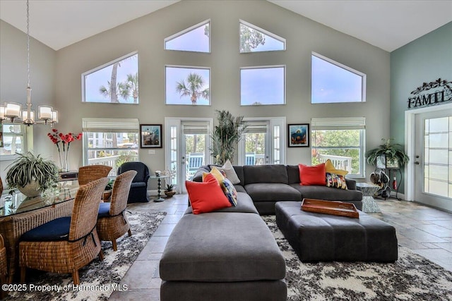 5233 Tuscawilla Dr, Weeki Wachee, FL 34607 - living area with a chandelier, high vaulted ceiling, and stone tile flooring