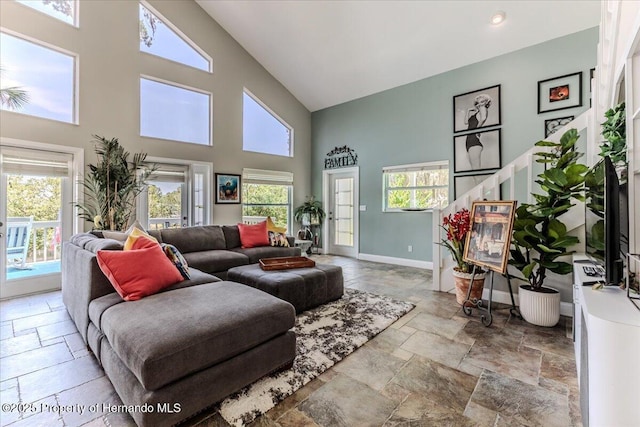 5233 Tuscawilla Dr, Weeki Wachee, FL 34607 - living area with high vaulted ceiling and stone tile flooring