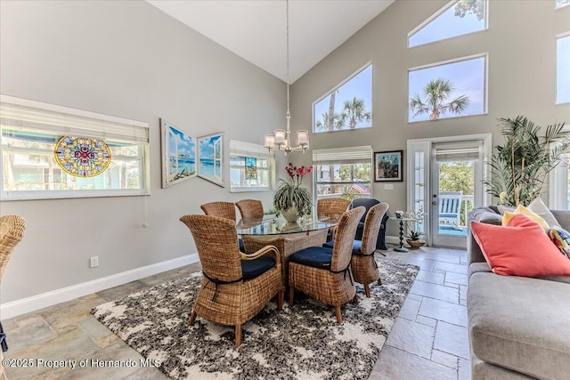5233 Tuscawilla Dr, Weeki Wachee, FL 34607 - dining room with stone tile floors, high vaulted ceiling, and a chandelier