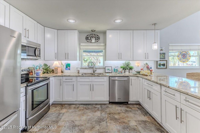 5233 Tuscawilla Dr, Weeki Wachee, FL 34607 - kitchen with stainless steel appliances, backsplash, and white cabinets