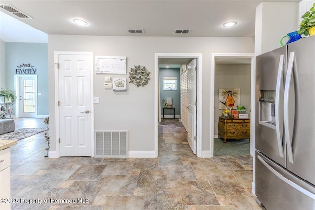 5233 Tuscawilla Dr, Weeki Wachee, FL 34607 - kitchen featuring stainless steel refrigerator with ice dispenser, light stone finish flooring, and light countertops