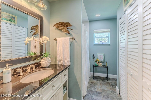 5233 Tuscawilla Dr, Weeki Wachee, FL 34607 - full bathroom with a closet, vanity, and stone finish flooring