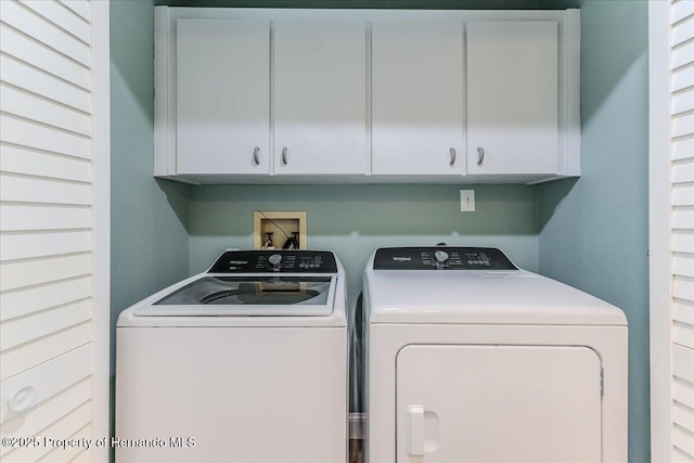 5233 Tuscawilla Dr, Weeki Wachee, FL 34607 - laundry area featuring cabinet space and washer and clothes dryer