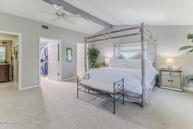 5233 Tuscawilla Dr, Weeki Wachee, FL 34607 - carpeted bedroom with multiple windows, a walk in closet, ensuite bath, and ceiling fan