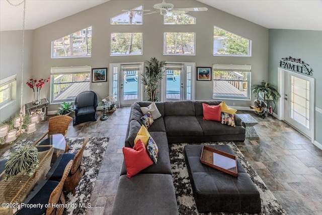 5233 Tuscawilla Dr, Weeki Wachee, FL 34607 - living area featuring stone tile flooring, high vaulted ceiling, and ceiling fan