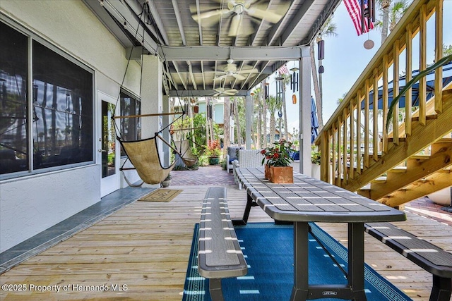 5233 Tuscawilla Dr, Weeki Wachee, FL 34607 - wooden deck with ceiling fan and stairs