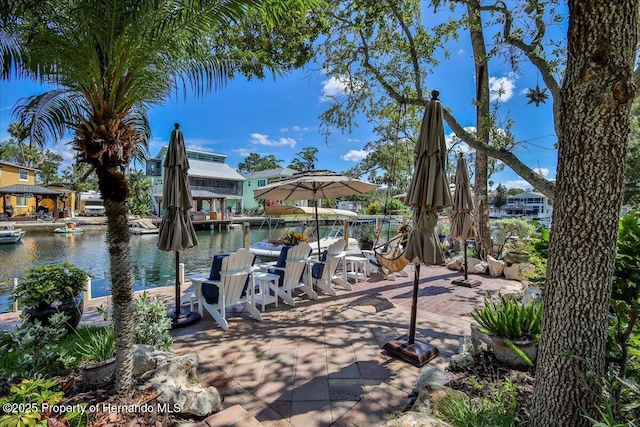 5233 Tuscawilla Dr, Weeki Wachee, FL 34607 - view of patio / terrace with a water view and a boat dock