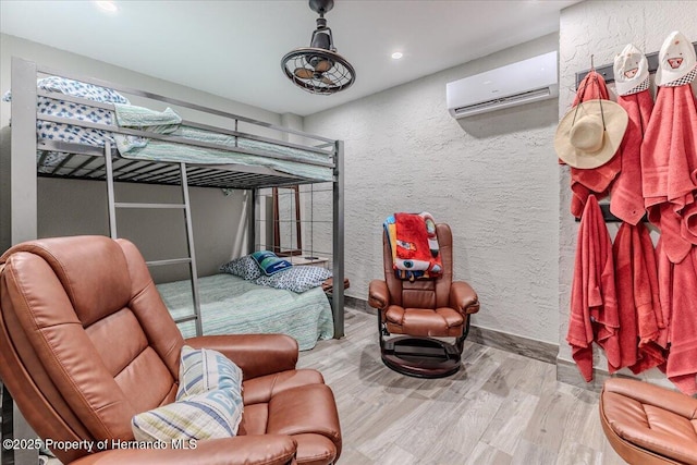 5233 Tuscawilla Dr, Weeki Wachee, FL 34607 - bedroom featuring a wall unit AC, a textured wall, wood finished floors, and recessed lighting