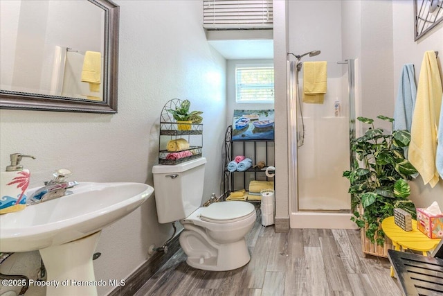 5233 Tuscawilla Dr, Weeki Wachee, FL 34607 - bathroom with a stall shower and wood finished floors