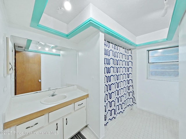13094 Huntington Woods Ave, Spring Hill, FL 34609 - full bathroom featuring vanity, a shower with shower curtain, tile patterned flooring, and a tray ceiling