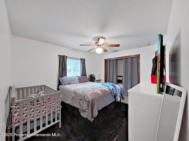 13094 Huntington Woods Ave, Spring Hill, FL 34609 - bedroom with a textured ceiling and ceiling fan