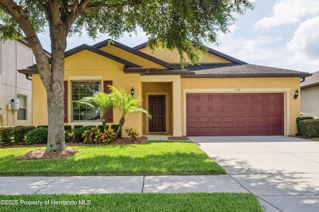 758 Alpine Thistle Dr, Brooksville, FL 34604 - view of front facade featuring a garage, stucco siding, concrete driveway, and a front yard