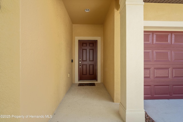 758 Alpine Thistle Dr, Brooksville, FL 34604 - view of exterior entry featuring stucco siding and a garage