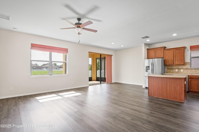758 Alpine Thistle Dr, Brooksville, FL 34604 - kitchen featuring stainless steel fridge, a kitchen island, open floor plan, ceiling fan, and backsplash