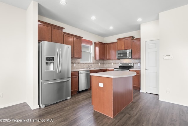 758 Alpine Thistle Dr, Brooksville, FL 34604 - kitchen with appliances with stainless steel finishes, a kitchen island, tasteful backsplash, light countertops, and dark wood-style flooring