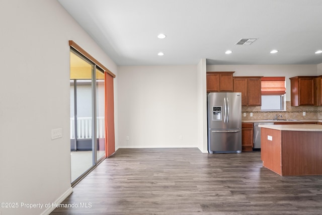 758 Alpine Thistle Dr, Brooksville, FL 34604 - kitchen with appliances with stainless steel finishes, light countertops, backsplash, dark wood-style floors, and recessed lighting