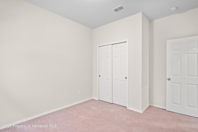 758 Alpine Thistle Dr, Brooksville, FL 34604 - unfurnished bedroom featuring light carpet and a closet