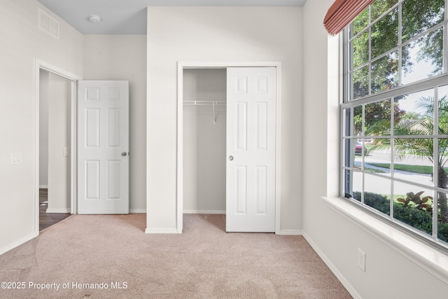 758 Alpine Thistle Dr, Brooksville, FL 34604 - unfurnished bedroom featuring light carpet and a closet