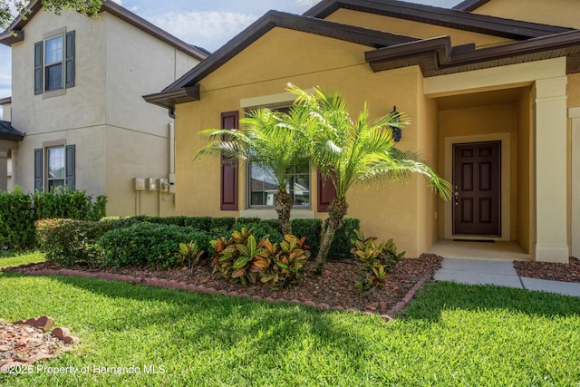 758 Alpine Thistle Dr, Brooksville, FL 34604 - entrance to property featuring a lawn and stucco siding
