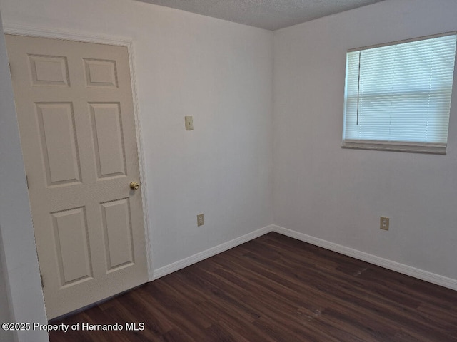 7344 California St, Brooksville, FL 34601 - spare room with dark wood-style flooring and baseboards