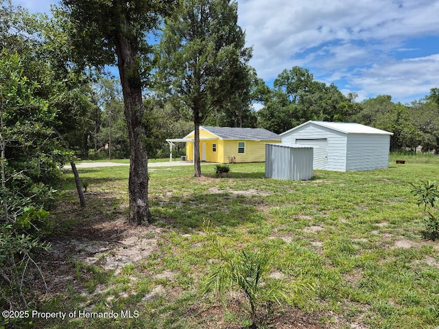 7344 California St, Brooksville, FL 34601 - view of green lawn with an outbuilding