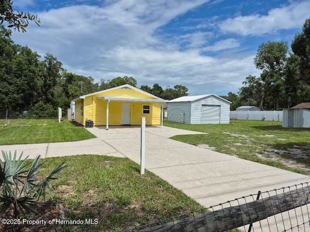 7344 California St, Brooksville, FL 34601 - view of front of home with a storage unit and concrete driveway