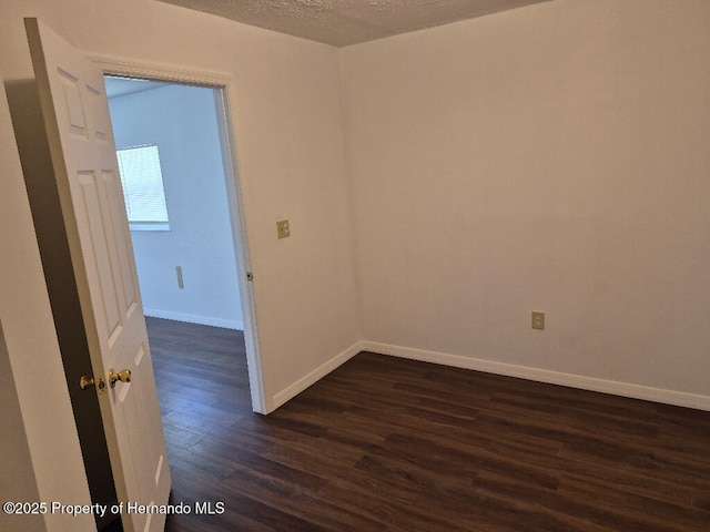 7344 California St, Brooksville, FL 34601 - unfurnished room featuring dark wood finished floors and a textured ceiling