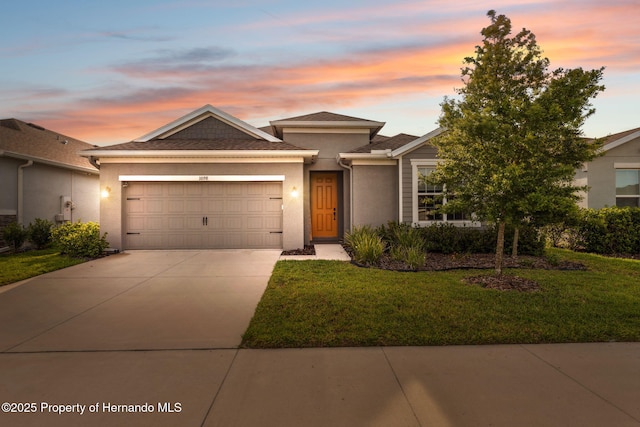 1098 Old Windsor Way, Spring Hill, FL 34609 - view of front of house with stucco siding, driveway, a garage, and a lawn