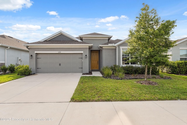1098 Old Windsor Way, Spring Hill, FL 34609 - view of front of property with stucco siding, a garage, a front yard, and concrete driveway